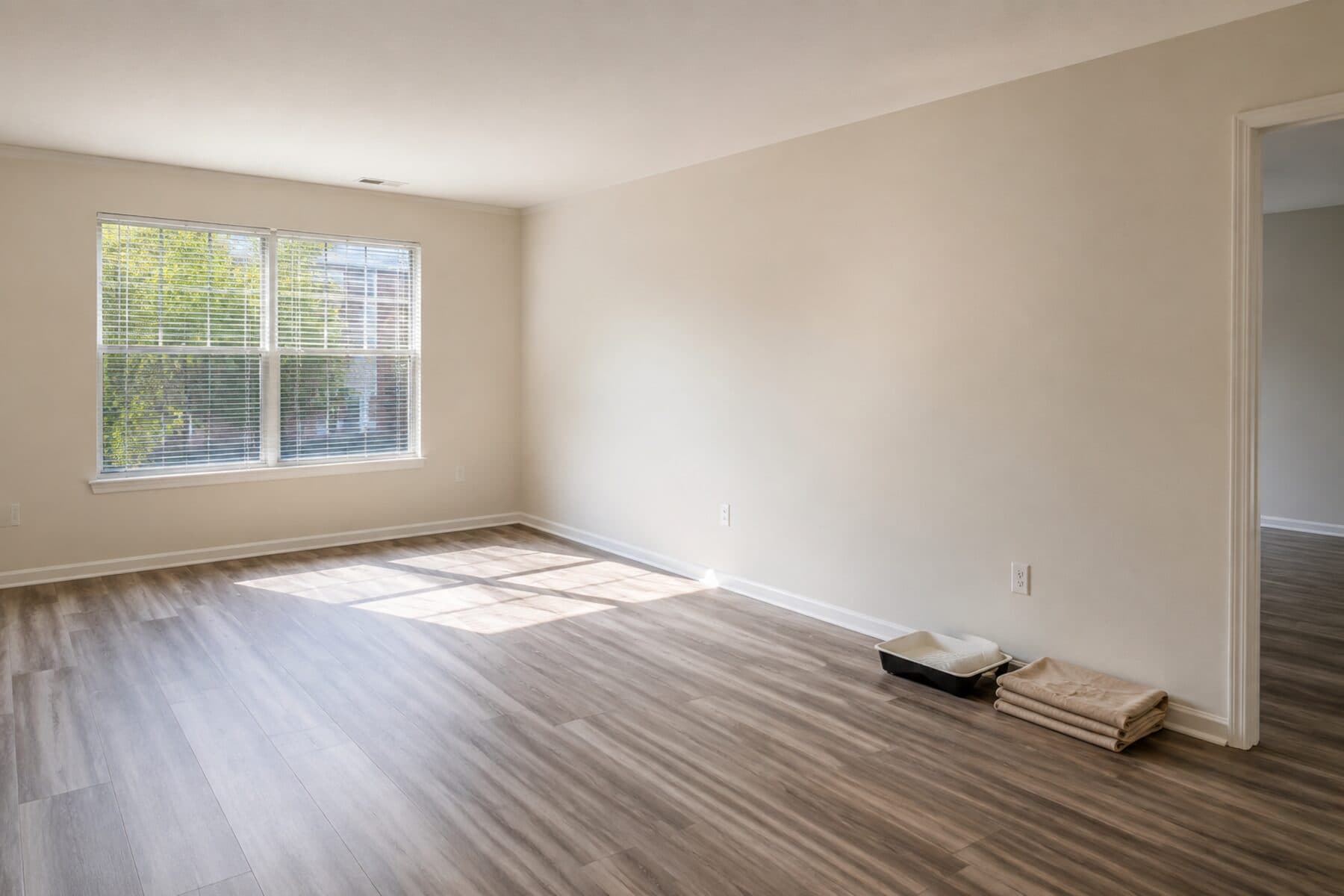 Freshly painted empty apartment unit with new flooring, ready for move-in